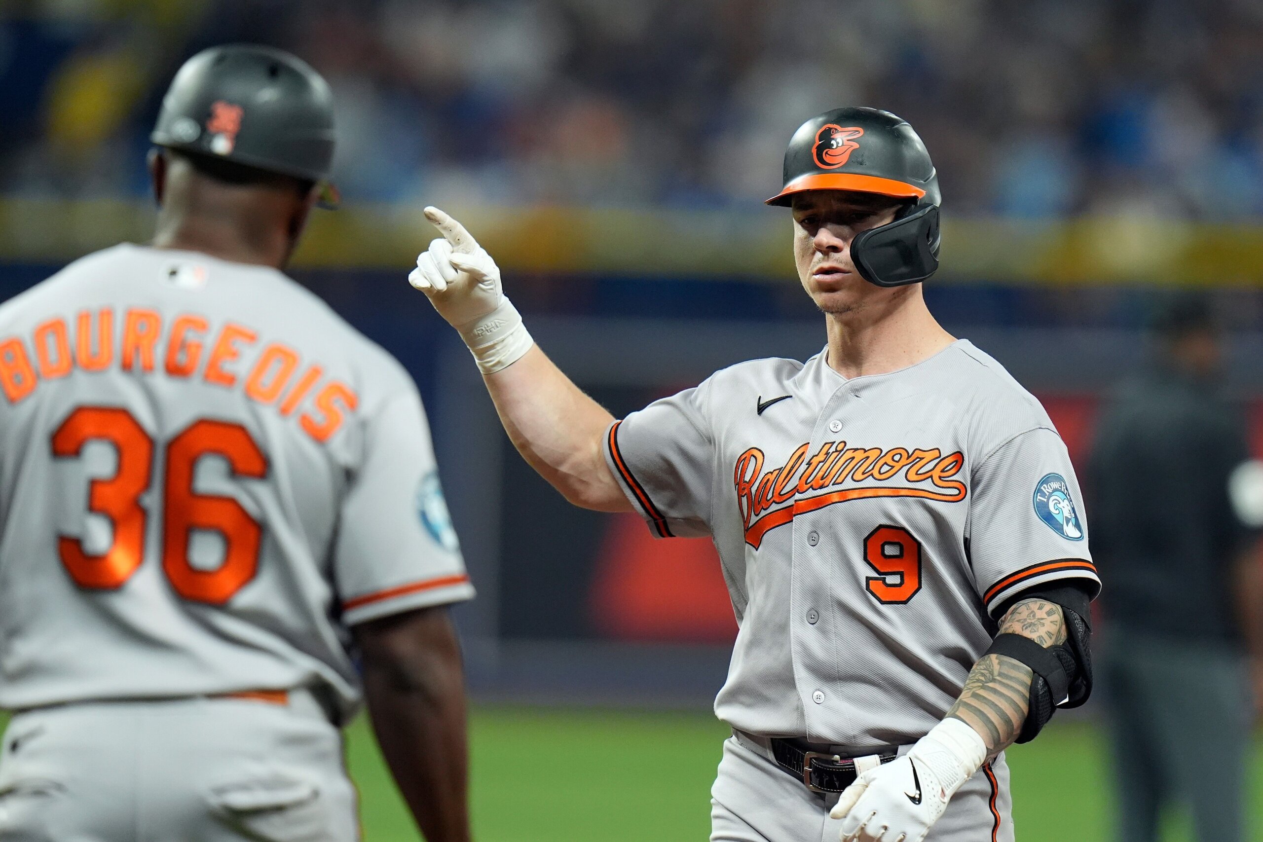 Baltimore Orioles' Tyler O'Neill (9) celebrates with first base coach Jason Bourgeois (36)