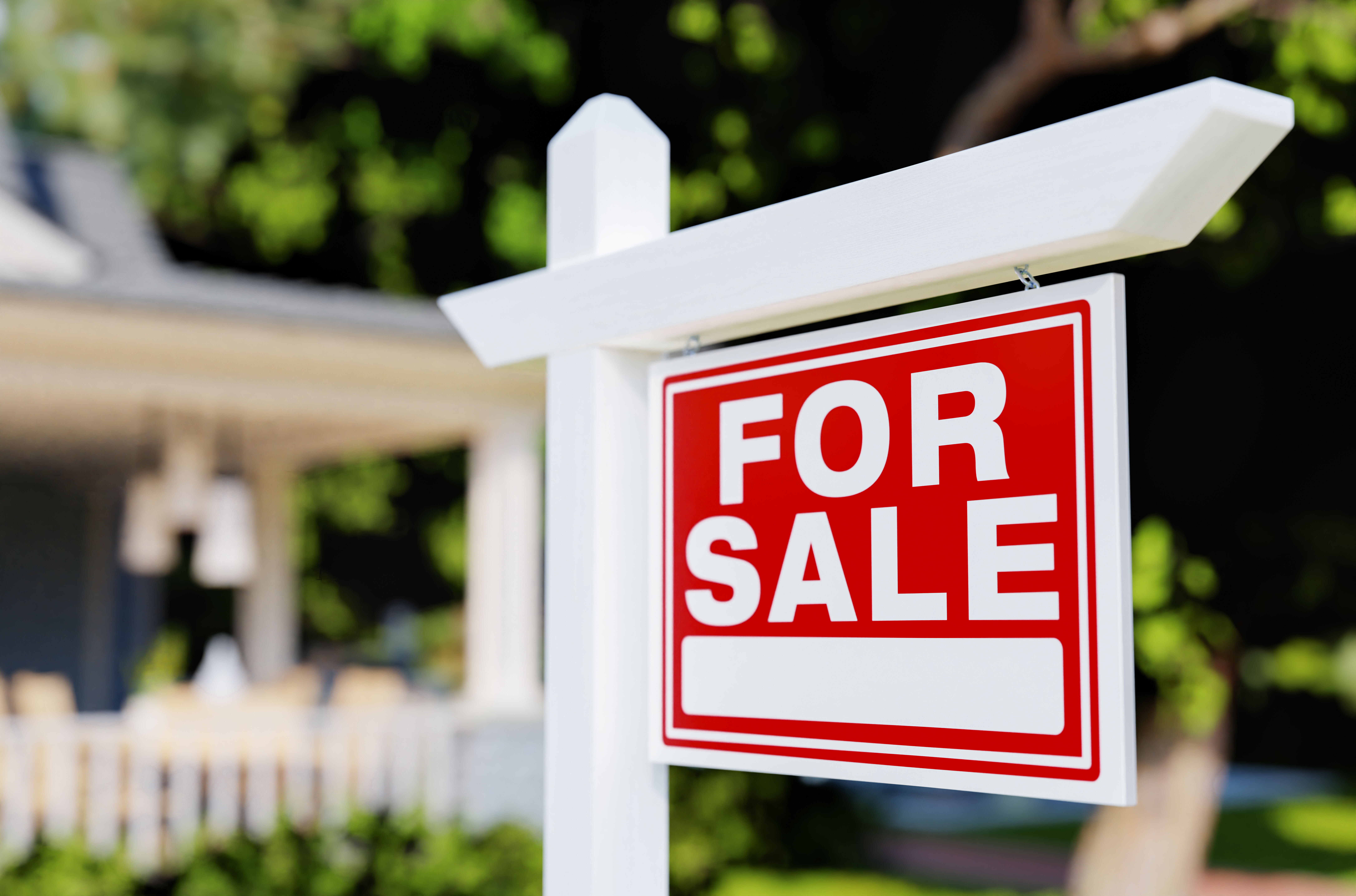 For Sale Real Estate Sign In Front of House.