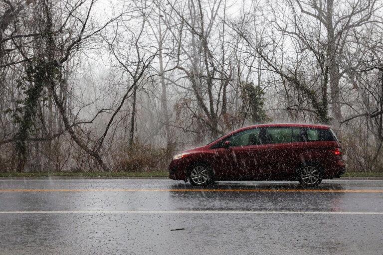 A car drives through heavy rain on Clara Barton Parkway