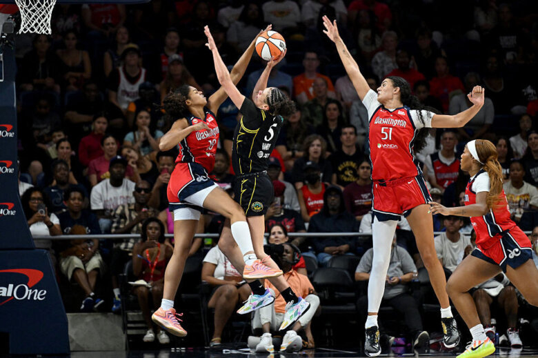 Cassandre Prosper (18) of the Washington Mystics blocks a shot by Dearica Hamby (5) of the Los Angeles Sparks