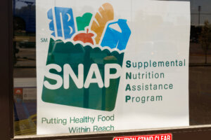 A Sign at a Retailer We Accept SNAP IV