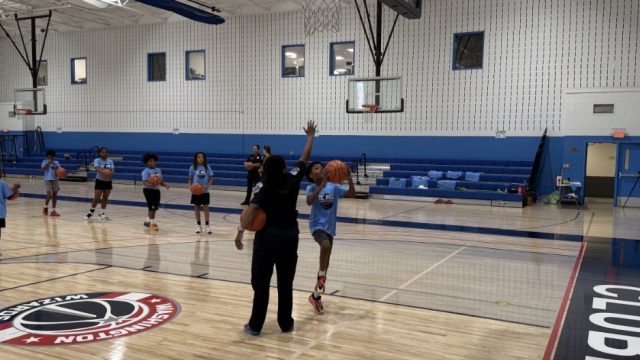 Local kids learn basketball skills at a camp with DC police officers