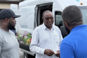 Three people in front of AfriThrive truck