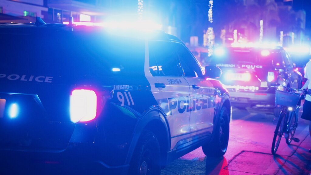 Police Cars with Blinking Lights on Miami Streets at Night
