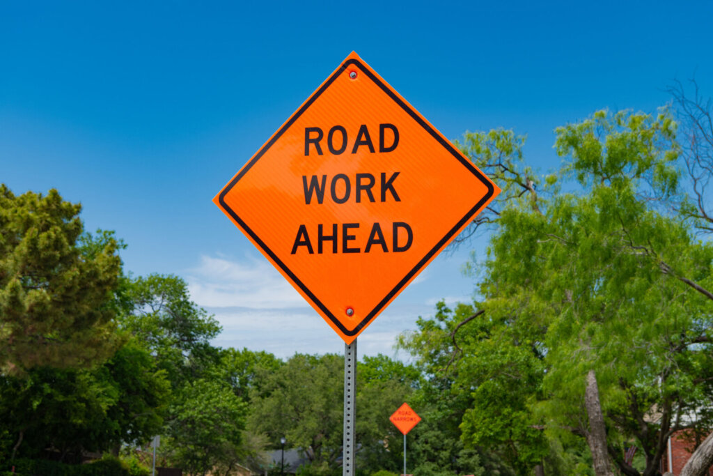 Sign of road work ahead. caution orange roadsign. traffic sign on the road. attention caution road sign. road work ahead